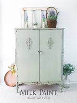 Cabinet painted with Homestead House’s Cartier Milk Paint, positioned beside a window with baskets and vases nearby.