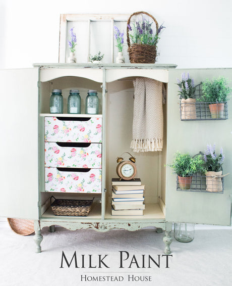 Vintage cabinet with floral-design drawers, books, jars, and lavender, painted in Cartier Milk Paint by Homestead House.