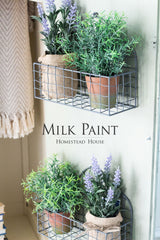 Two wire wall shelves with potted faux plants, lavender, and Homestead House Cartier Milk Paint decor accents.