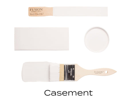 Brush, lid, and two paint swatches of Casement by Fusion Mineral Paint, warm white color shown.