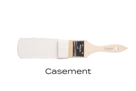 Paintbrush with Casement Fusion Mineral Paint, warm white, labeled below on a plain white background.