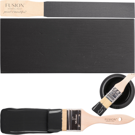 Three paint swatches, a brush, and Fusion Mineral Paint Cast Iron beside an open off-black furniture paint can.