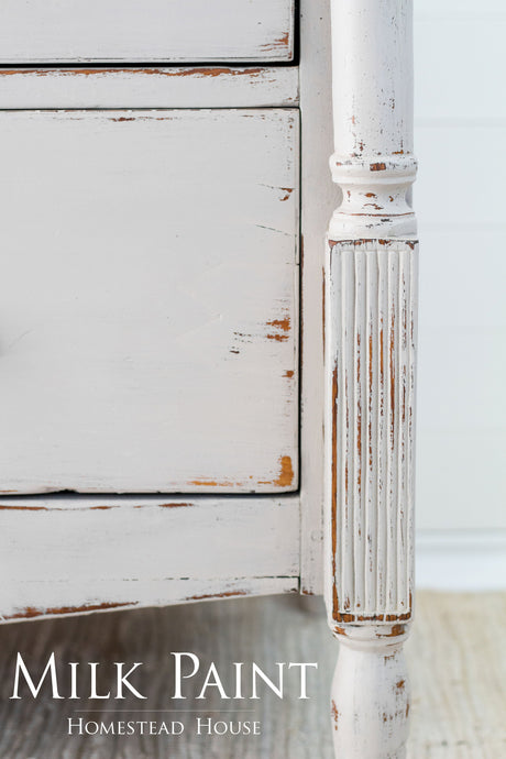 Cathedral Taupe Milk Paint by Homestead House displayed on a white distressed dresser leg, brand name bottom left.