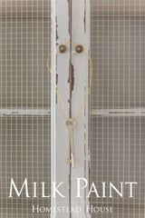 Vintage key hanging on white wire mesh cabinet finished in Cathedral Taupe Milk Paint by Homestead House.