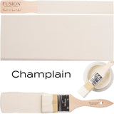 Fusion Mineral Paint Champlain with paintbrush, sample swatch, and open can of all-in-one acrylic paint.