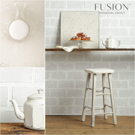 A white teapot and pastries on a shelf painted in Champlain Fusion Mineral Paint, set against a brick wall.