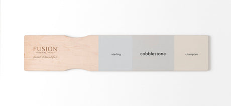Three Fusion Mineral Paint gray swatches—Sterling, Cobblestone, and Champlain—displayed on a wooden board.