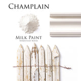 Champlain Milk Paint by Homestead House shown as powder, applied on molding, and on a distressed off-white picket fence.