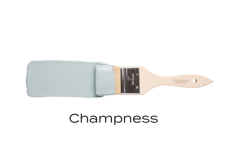 Paintbrush with light blue, matte Champness Fusion Mineral Paint by Fusion Mineral Paint on white background.
