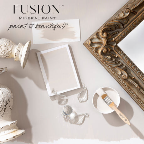 Swatch, brush, bowl, and frame displayed with Fusion Mineral Paint Chateau warm neutral grey on a light surface.