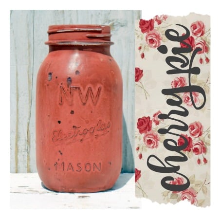 Red mason jar painted in Cherry Pie by Old Fashioned Milk Paint next to floral paper with cherry pie script.