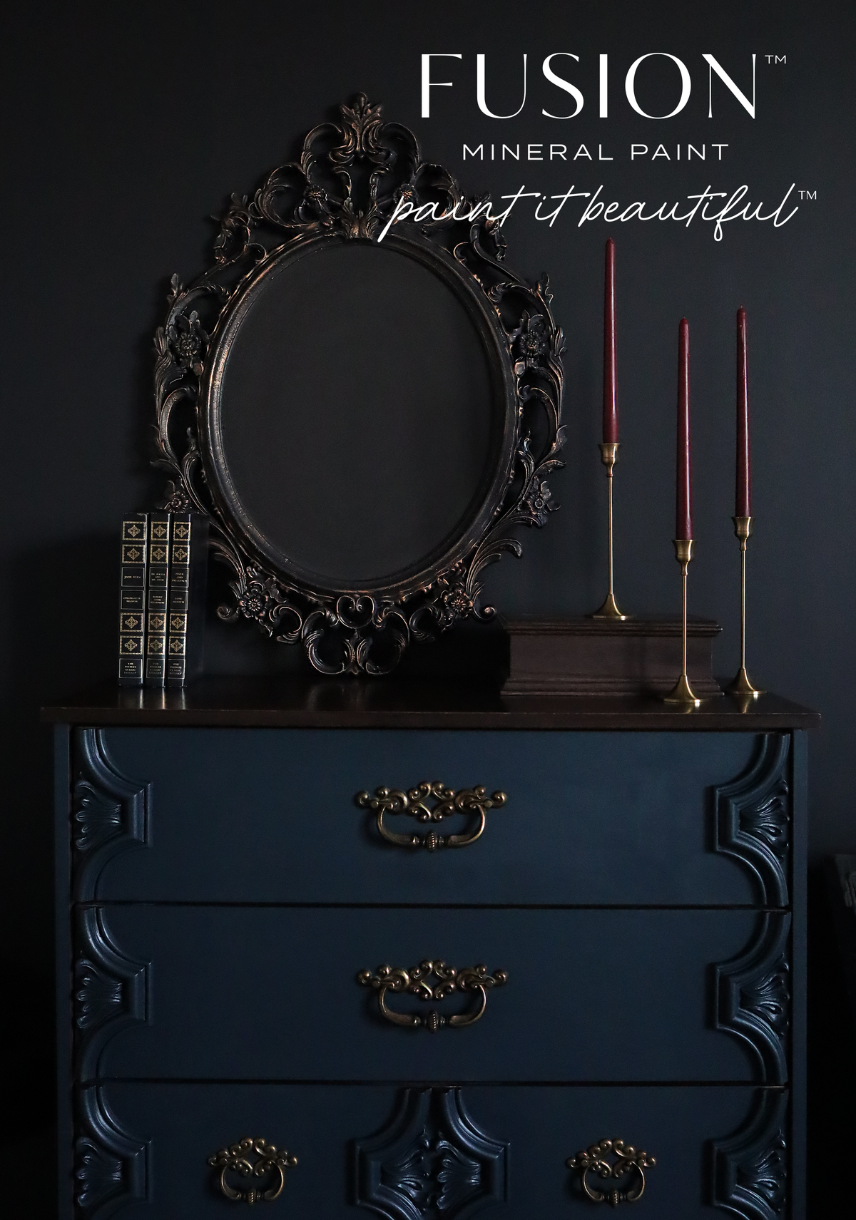 Navy dresser in Chestler by Fusion Mineral Paint, matte finish, topped with a dark ornate mirror and candles.