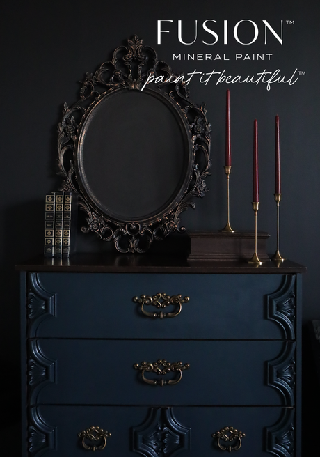 Navy dresser in Chestler by Fusion Mineral Paint, matte finish, topped with a dark ornate mirror and candles.