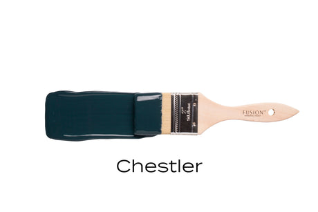 Paintbrush with dark blue Fusion Mineral Paint labeled Chestler.