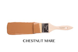 Brush dipped in brown paint, labeled “Chestnut Mare Fusion Mineral Paint” by Fusion Mineral Paint, rests below.