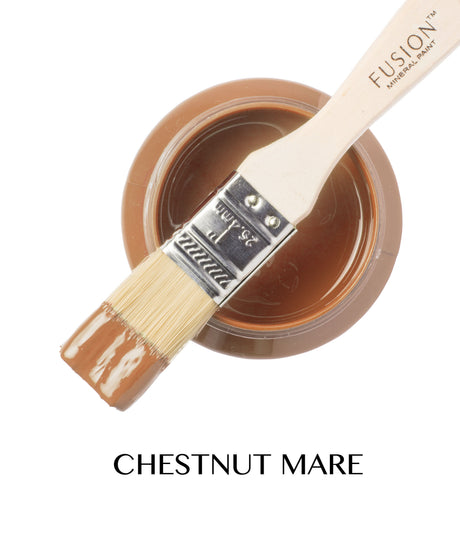 Open jar of Fusion Mineral Paint Chestnut Mare with a brush dipped in brown paint resting on top.