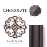 Homestead House Chocolate Milk Paint powder, painted sample, and wood trim, all labeled with product and color name.