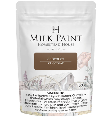 50g Homestead House Chocolate Milk Paint bag with wagon wheel, flowers, and health warnings on the packaging.