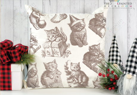 White pillow with brown kittens made using I.O.D. Christmas Kitties Stamp (2023 Limited Release), next to gift boxes.