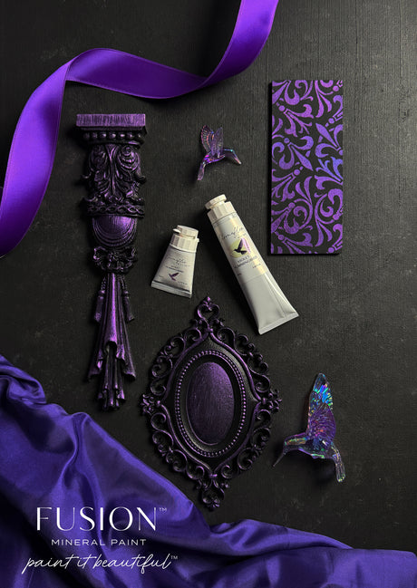 ChromaFlex paint tubes and Fusion Mineral Paint with purple ribbon, ornate items, butterflies, and card.
