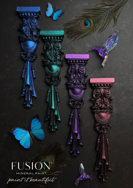 Set of four wood appliques with butterflies and feathers, painted in blue, green, purple, and magenta ChromaFlex.