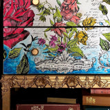 Drawer fronts with floral art, gold knobs, and ornate gold trim made using I.O.D. Classic Elements Mould.