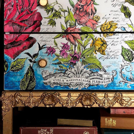 Drawer fronts with floral art, gold knobs, and ornate gold trim made using I.O.D. Classic Elements Mould.