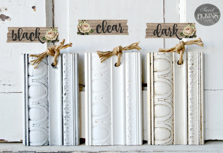 Three natural finish wood samples with knotted twine: Black, Old Fashioned Milk Paint Clear Oil Wax, and Dark.