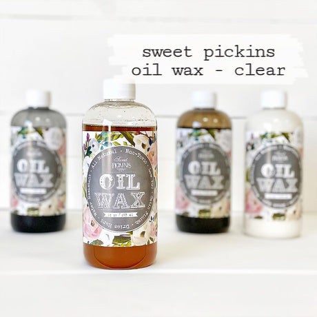 Four Sweet Pickins Clear Oil Wax bottles from Old Fashioned Milk Paint, with the clear bottle in the center.