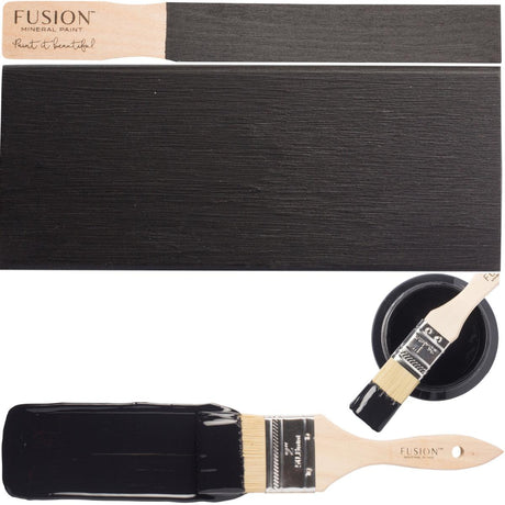 Wooden paintbrush with a painted strip and Coal Black Fusion Mineral Paint by Fusion Mineral Paint.
