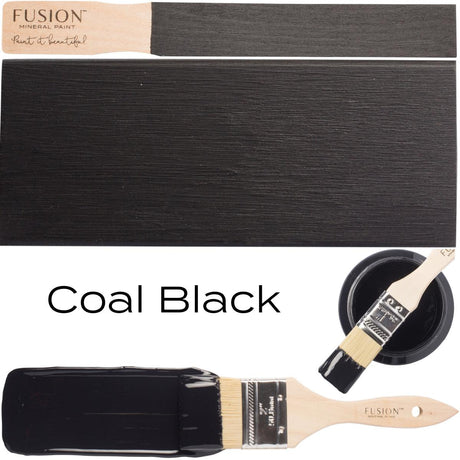 Wooden paintbrush with Coal Black Fusion Mineral Paint beside a painted surface showing the paint’s color.