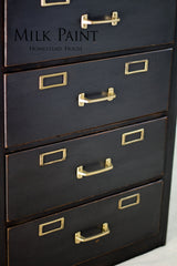 Four-drawer dark wood filing cabinet with brass handles, finished in Homestead House Coal Black Milk Paint.