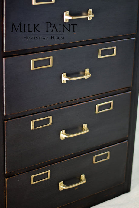 Four-drawer dark wood filing cabinet with brass handles, finished in Homestead House Coal Black Milk Paint.