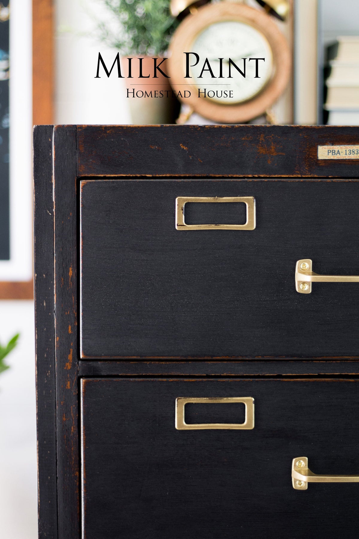 Dark wood cabinet with brass handles, finished in Homestead House Coal Black Milk Paint.