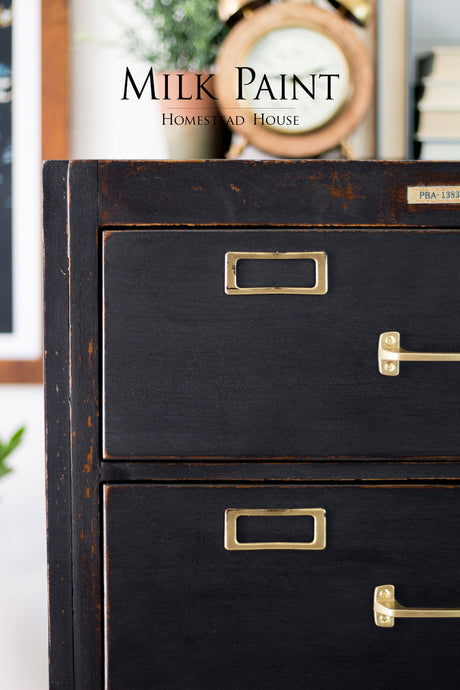 Dark wood cabinet with brass handles, finished in Homestead House Coal Black Milk Paint.