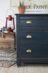 Navy dresser in Homestead House Coal Black Milk Paint with brass handles.