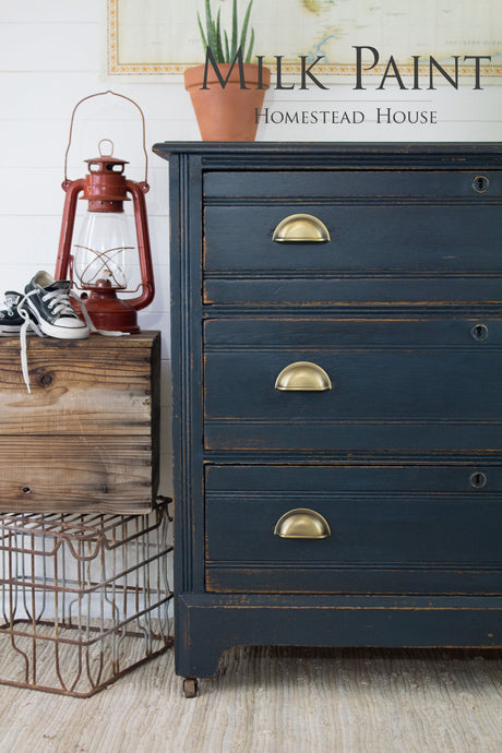 Navy dresser in Homestead House Coal Black Milk Paint with brass handles.