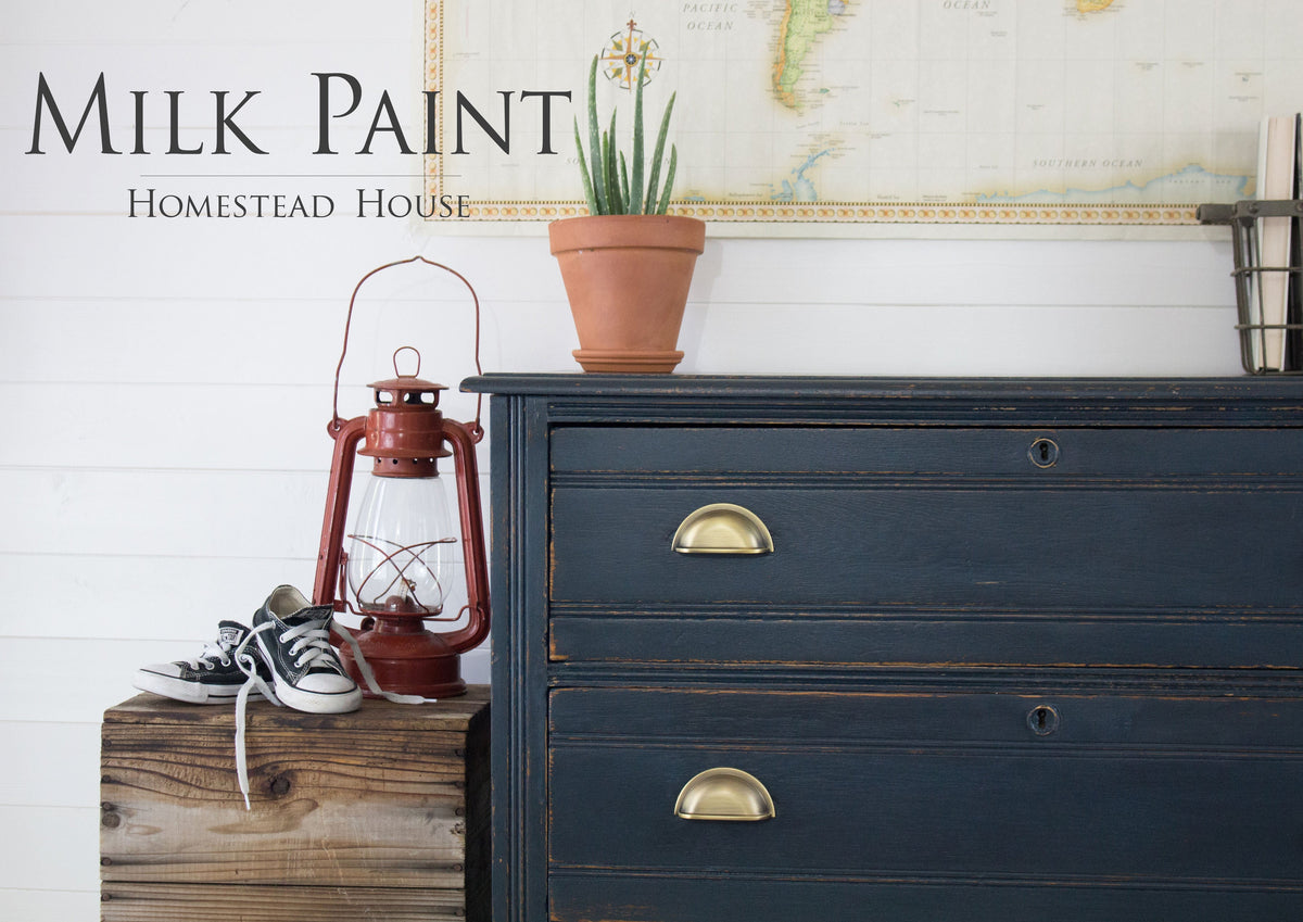 Dresser painted with Homestead House Coal Black Milk Paint, positioned near a map and red lantern.