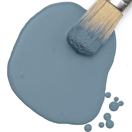 Brush on Fusion Mineral Paint Coastal Blue Milk Paint, with droplets visible on a white surface.