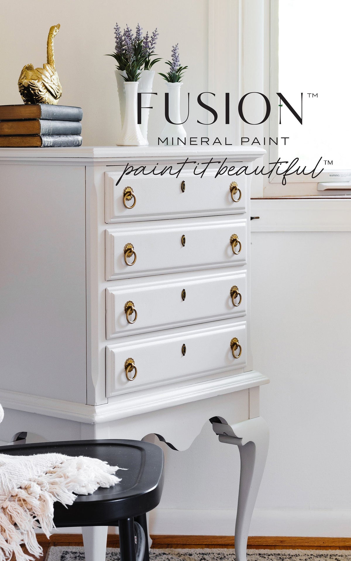 Dresser in Cobblestone Fusion Mineral Paint with gold handles, topped with books and décor.