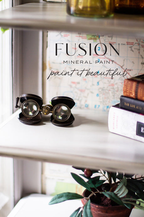 Shelf displaying vintage finds painted in Cobblestone, a warm grey shade by Fusion Mineral Paint.