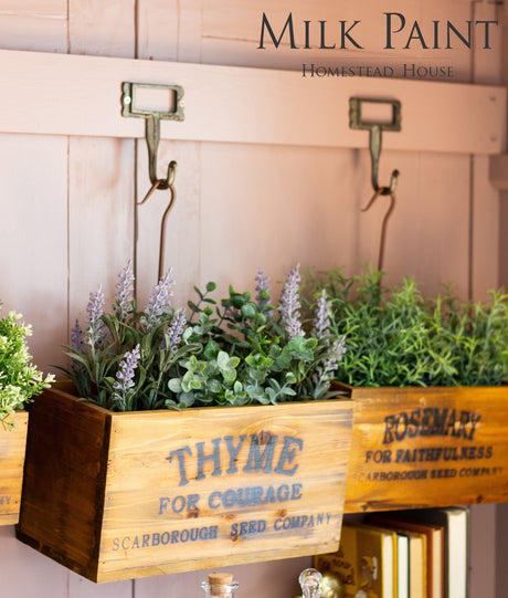 Two wooden boxes labeled Thyme and Rosemary, painted with Combed Wool Milk Paint, holding faux greens and blooms.