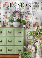 Conservatory Fusion Mineral Paint mid-tone green dresser with potted plants, set against botanical print wall.