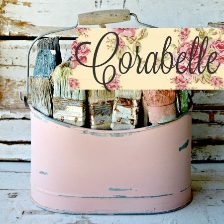Pink tin with paintbrushes and Corabelle floral label on Old Fashioned Milk Paint.