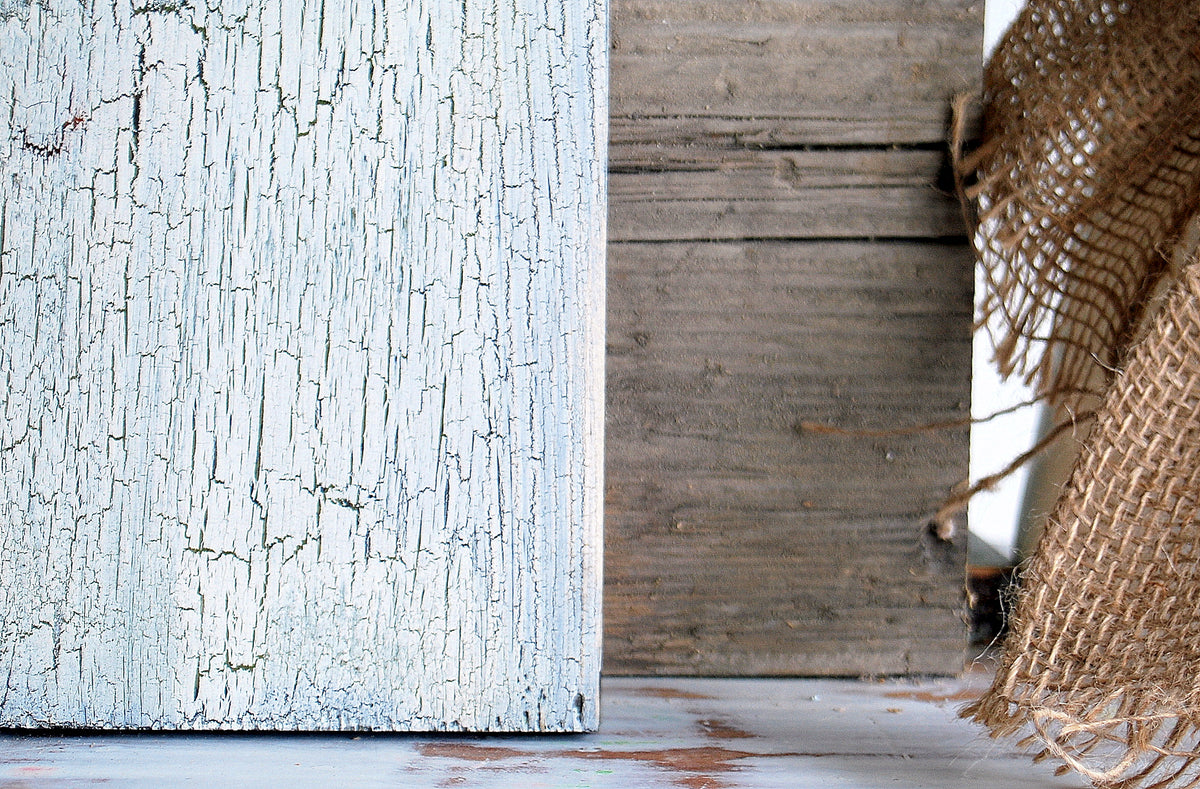 Crackle by Old Fashioned Milk Paint on wood, plain brown wood, and frayed burlap fabric displayed side by side.