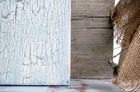 Crackle by Old Fashioned Milk Paint on wood, plain brown wood, and frayed burlap fabric displayed side by side.