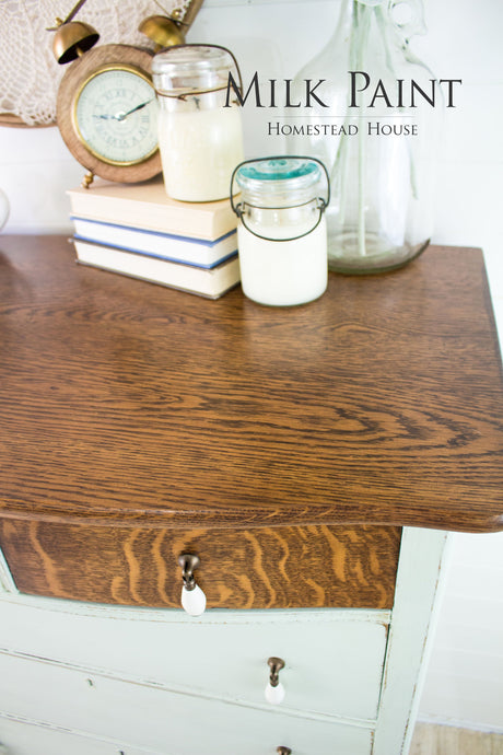 Dresser with decor featuring Homestead House Craftsman Milk Paint showing smooth, flawless paint coverage.