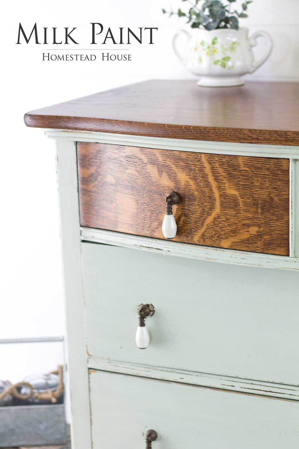 Wood dresser painted light green (Homestead House Craftsman Milk Paint) with a teapot of fresh greenery on top.