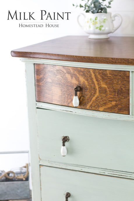 Wood dresser painted light green (Homestead House Craftsman Milk Paint) with a teapot of fresh greenery on top.