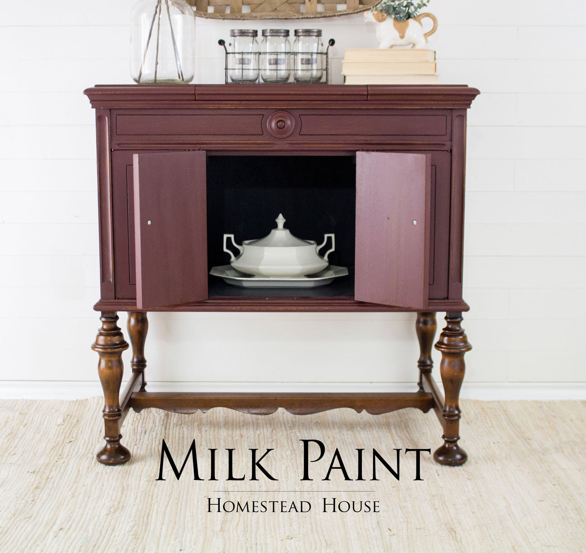 Dark wood sideboard with open door revealing white dish; text reads Cranberry Milk Paint by Homestead House.